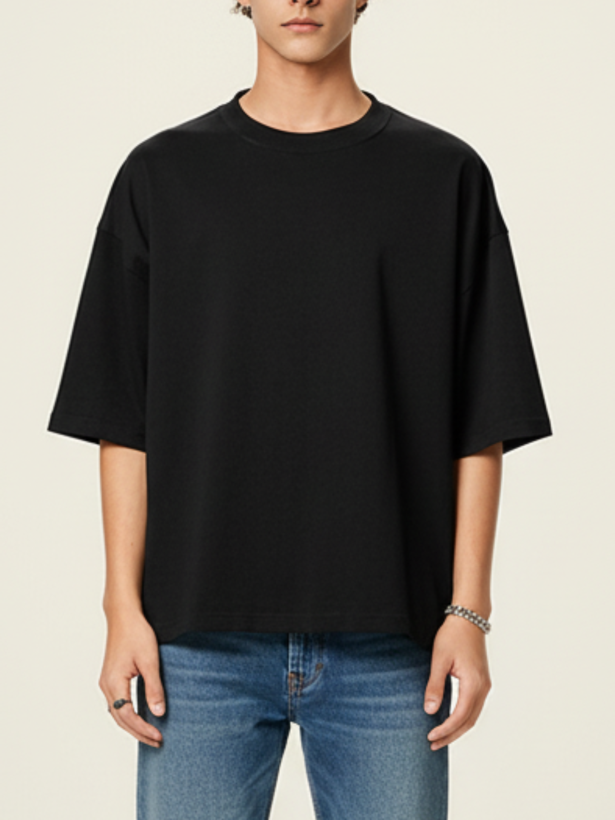 Aero boxy crop tee in black by Apollo Moda, styled with blue jeans on a beige background